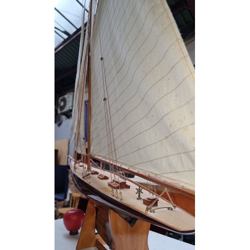 393 - Star lot : A very large Wooden model sailboat with white sails. Base included for display. About 4'6... 