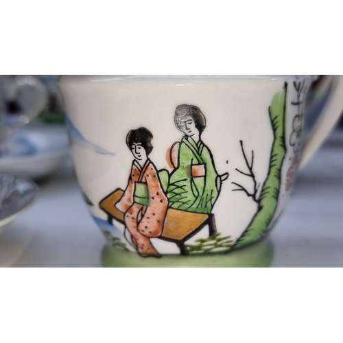 395 - E&O China Ware tea set features hand-painted Asian landscape motifs. The set includes a teapot, suga... 