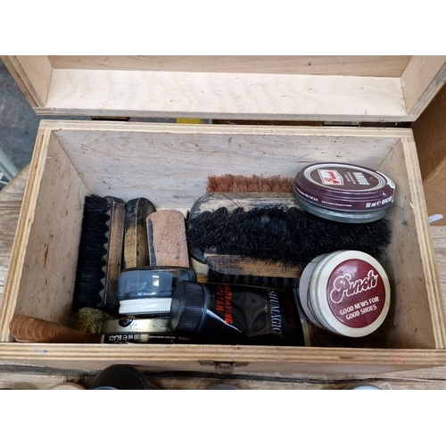 413 - Wooden shoe shine box full with assorted brushes, polishes, and accessories. Brands include Punch an... 