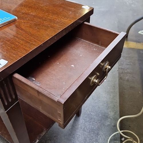 417 - Wooden side table with brass handles, featuring a single drawer and lower shelf. Emphasizes practica... 