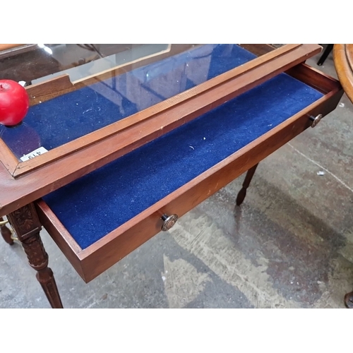 419 - Star Lot : Edwardian display table with glazed top, mahogany construction, ornate carved legs, and b... 