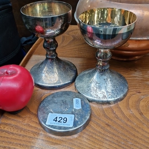 429 - Pair of antique silver plated Communion  goblets featuring a cross emblem, with gilt interior and a ... 