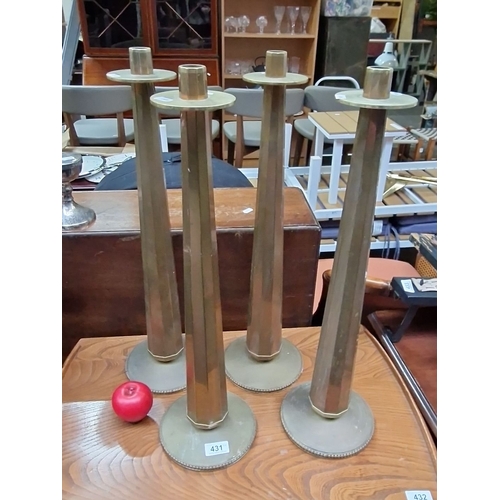 431 - Set of four large church  brass candlesticks with hexagonal stems and beaded base detailing, from  t... 