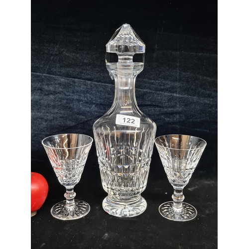 122 - A beautiful Waterford Crystal decanter along with two stemmed drinking glasses in the Tramore patter... 