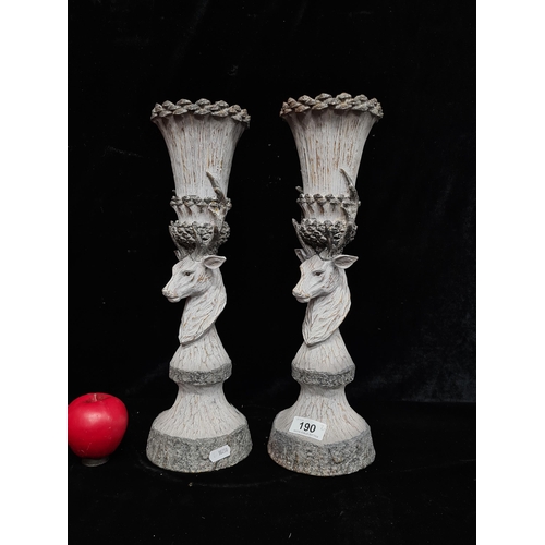 190 - A pair of tall pillar candlesticks in the form of stags heads. Ideal for Christmas centerpieces. Bra... 