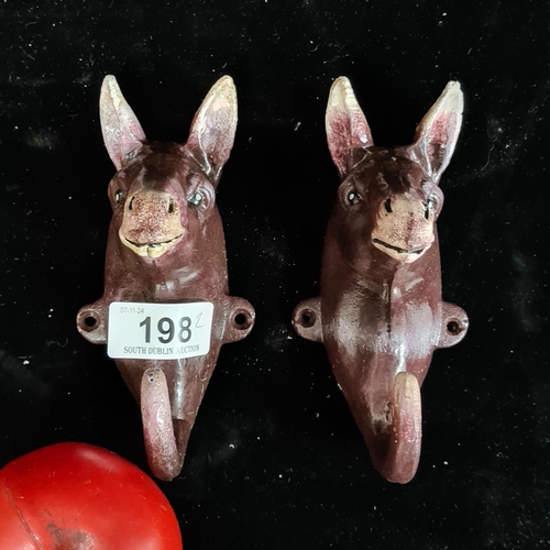 198 - A pair of charming hand painted heavy cast iron coat hooks in the form of donkeys.