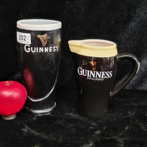 202 - Two Guinness branded items including an official merchandise Guinness ceramic jug and a Guinness pin... 