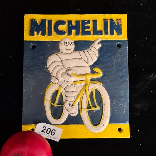 206 - A heavy cast iron wall sign featuring the Michelin Man on a bike with the word Michelin on the top. ... 