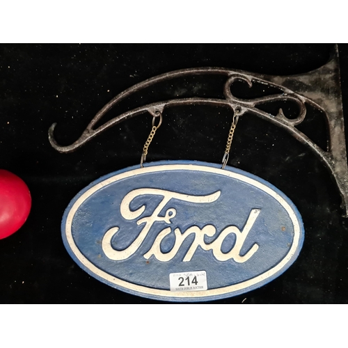 214 - A hand painted  heavy cast metal wall mounted bracket and double side sign advertising Ford.