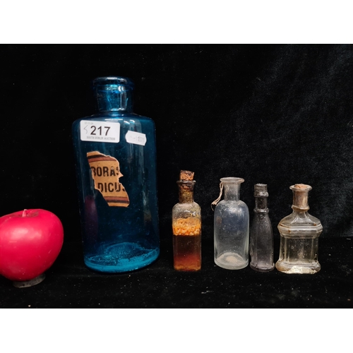 217 - Five antique chemist bottles. Inc a large Poison bottle with partial paper label./