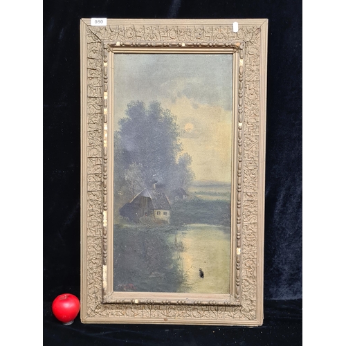 80 - An original antique oil on canvas painting. Features an evening scene with a quaint cottage seated b... 