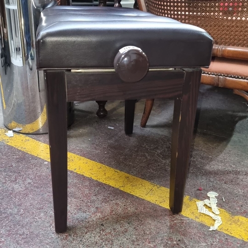 440 - Adjustable piano bench featuring dark wood legs and tufted black faux leather seat.