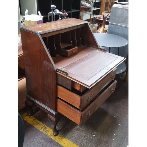 443 - Antique mahogany writing bureau with drop-front, featuring three drawers and multiple interior compa... 