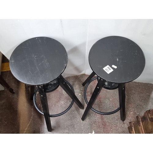 453 - Pair of industrial-style adjustable black metal stools with circular seats and tripod legs. Could al... 