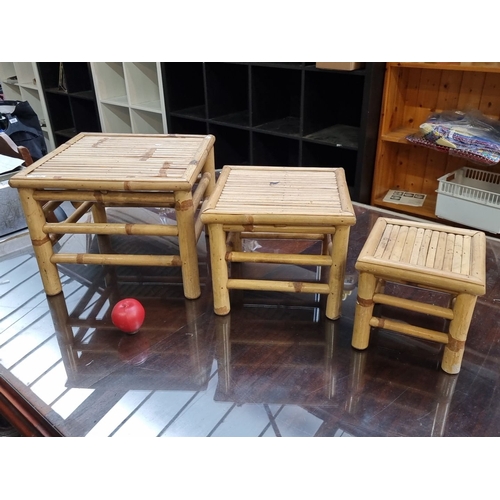 462 - Set of three nesting bamboo tables, featuring a natural finish and minimalist design.