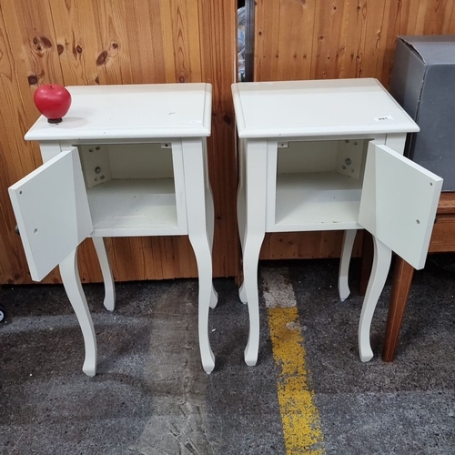 491 - Pair of white wooden bedside tables with single cabinet door, featuring curved legs and a minimalist... 