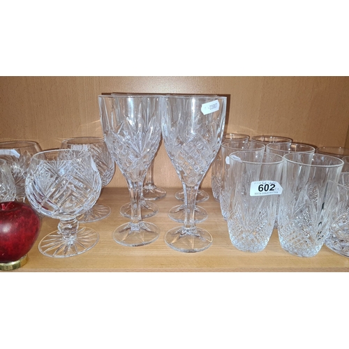 602 - Collection of cut crystal glassware, including wine glasses, cocktail glasses, and tumblers. Feature... 