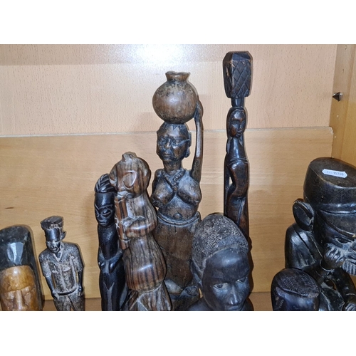 607 - Collection of African tribal wooden sculptures, various sizes and styles, depicting human figures an... 