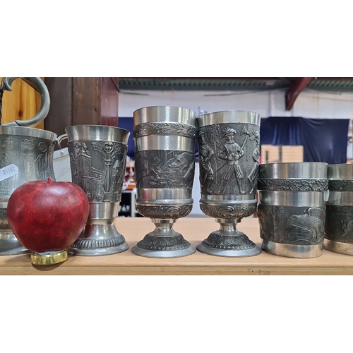 626 - A very large Collection of decorative pewter items includes a pitcher, six goblets, and a mantle clo... 