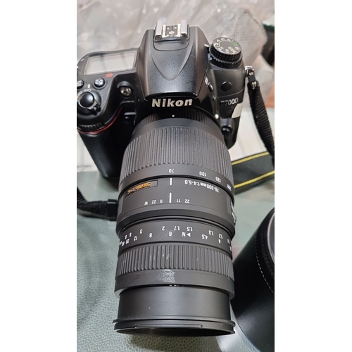 637 - Star Lot : A Nikon D7000 SLR Digital camera with Sigma 70-300mm lens, battery charger, additional ac... 