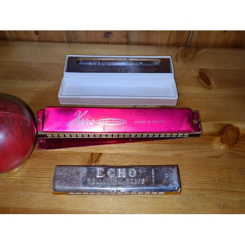 639 - Set of three harmonicas: Hero in pink casing, Echo Bell Metal Reeds, and vintage M. Hohner with embo... 