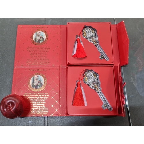 643 - Set includes two keys with Santa motif and red tassels, presented in decorative red boxes with gold ... 