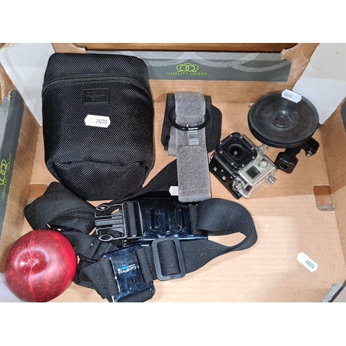 648 - GoPro camera set with accessories, including mounts and carrying case.