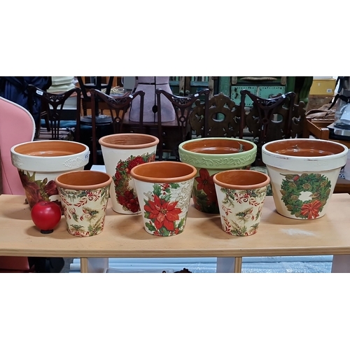 653 - Hand-decorated and decoupaged terracotta pots. Festive floral designs. Set of seven.