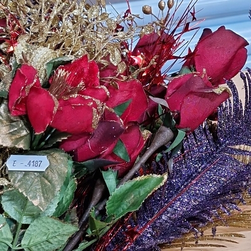 655 - Artificial floral arrangement features red roses, gold foliage, and decorative accents.