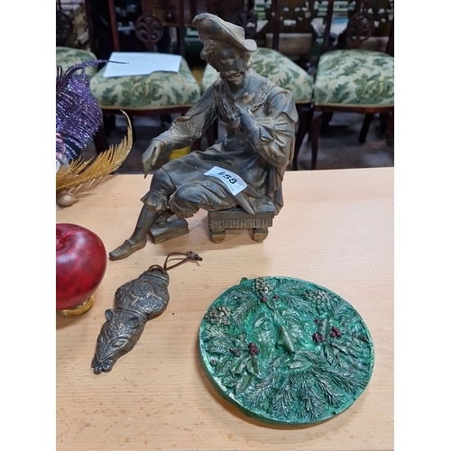 658 - Bronze figure of a seated man in traditional attire and a green ceramic wall plaque. Includes Wild G... 