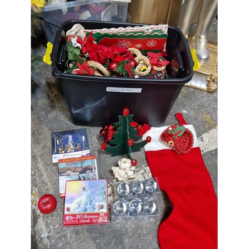 670 - A big box of Christmas decorations include cards, ornaments, wreaths, artificial poinsettias, and a ... 