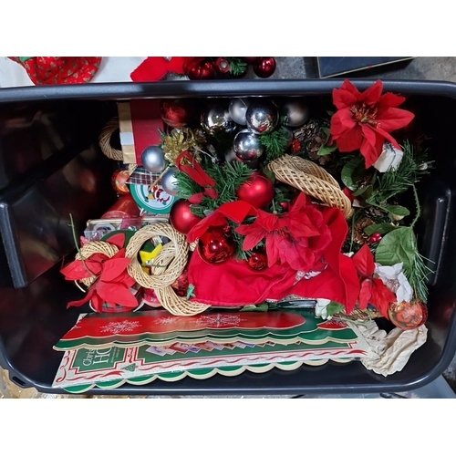 670 - A big box of Christmas decorations include cards, ornaments, wreaths, artificial poinsettias, and a ... 