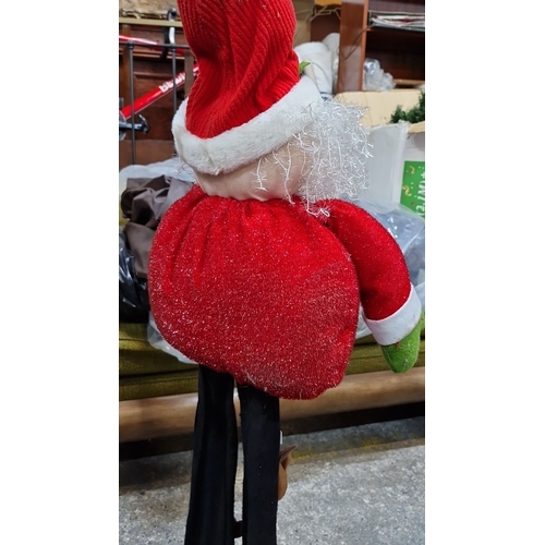 672 - Festive Approx 4 feet tall fabric Santa Claus figure features a plush beard, red outfit, and elongat... 