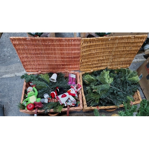 677 - Two wicker baskets of assorted Christmas decorations, including plush toys, artificial greenery, and... 