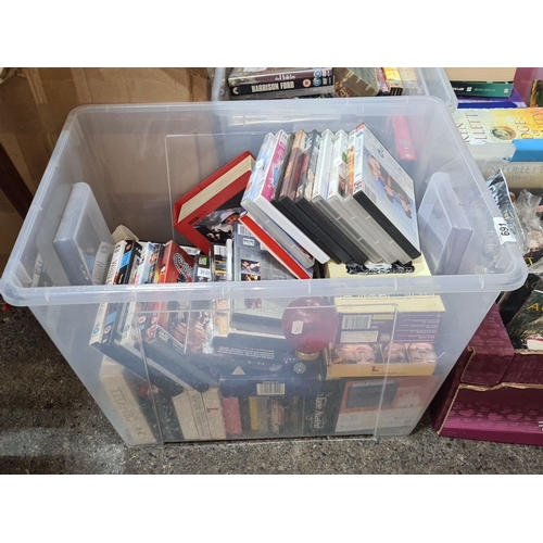 691 - Collection of assorted DVDs in a plastic storage box with various film titles and genres.