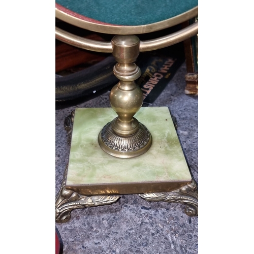 882 - Victorian-style brass vanity mirror with an oval frame and ornate base. Features green felt backing.