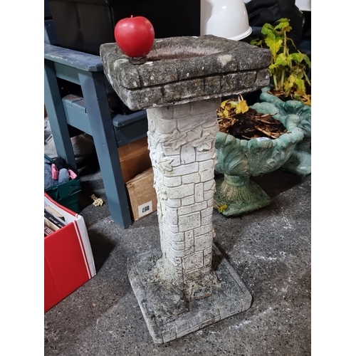 906 - A Stone bird bath with ivy detailing, featuring a brickwork design.