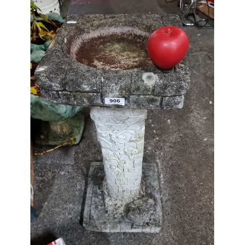 906 - A Stone bird bath with ivy detailing, featuring a brickwork design.