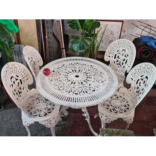 912 - Star lot :Victorian-style cast iron garden set, featuring intricate floral and scroll designs. Inclu... 