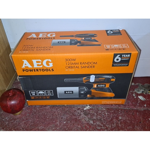 913 - A new in box AEG Powertools 300W 125mm Random Orbital Sander, model EX 125 ES. Comes with a 6-year p... 