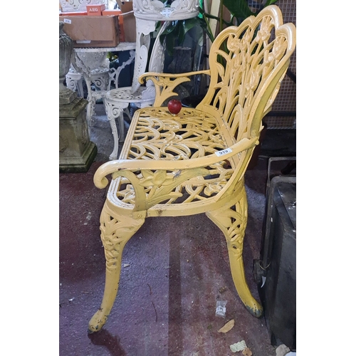 919 - Star lot ;A Victorian-style cast iron garden bench with intricate floral motif in vibrant yellow fin... 