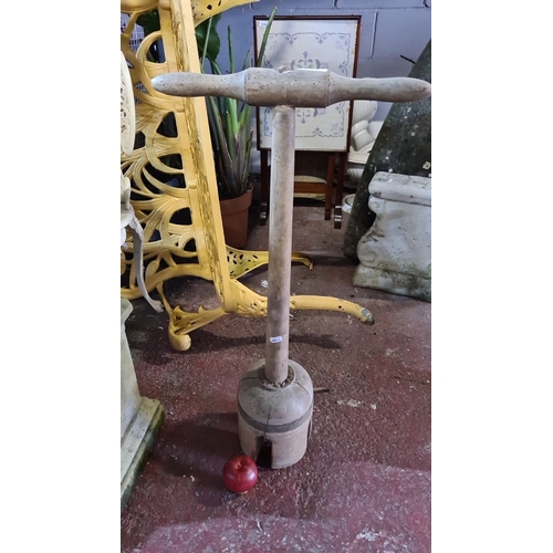 922 - An Antique wooden dolly with turned handle and split base. A rustic tool with historical appeal.