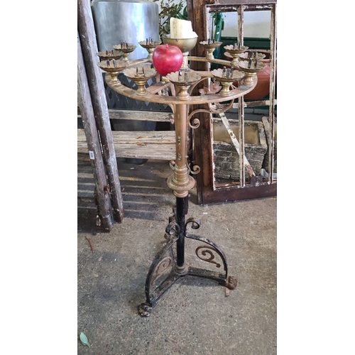 932 - Star lot.  An Antique wrought iron and brass church candelabra with ornate detailing and 12 candle h... 