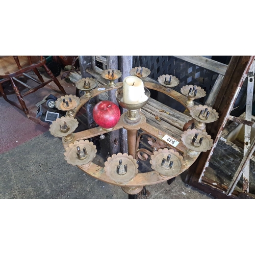 932 - Star lot.  An Antique wrought iron and brass church candelabra with ornate detailing and 12 candle h... 