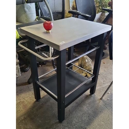 934 - Stainless steel kitchen cart with side handle and lower storage shelf.