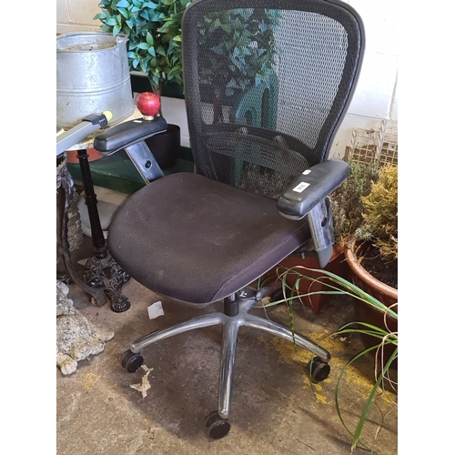 938 - Office chair with mesh back, adjustable armrests, and swivel base. Modern design. A good sturdy exam... 