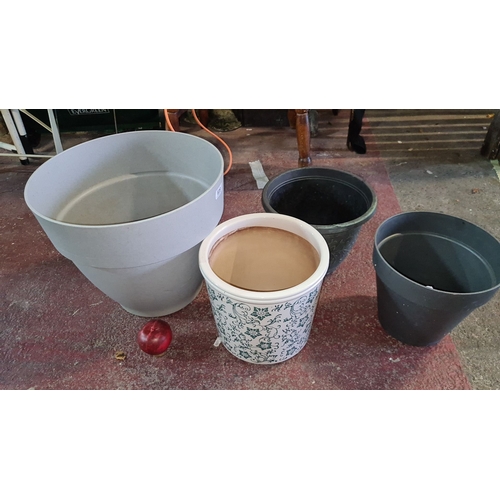 939 - Set of four mixed plant pots, featuring varied materials and styles, including ceramic with decorati... 