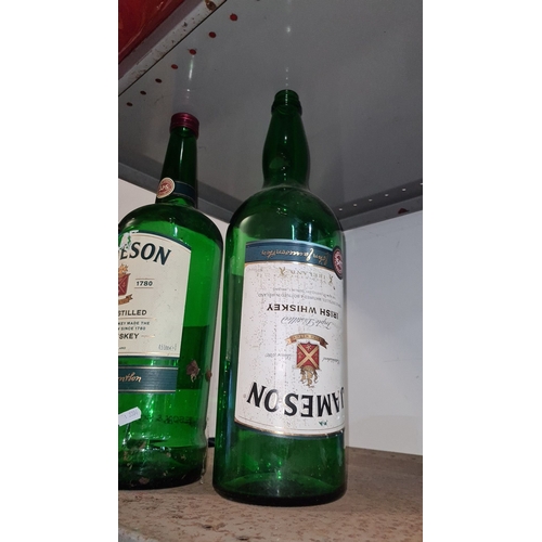 968 - Pair of oversized Jameson Irish Whiskey display bottles, 4.5 liters each, green glass, featuring ico... 