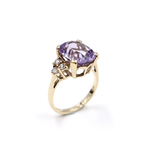 29 - Star Lot : A nine carat gold amethyst stone ring with gemstone accents. Size - K 1/2. Weight - 3.3 g... 