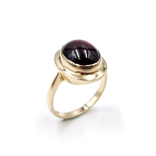 33 - An excellent example of a cabochon garnet stone ring set in nine carat gold. Ring size - P. Weight -... 